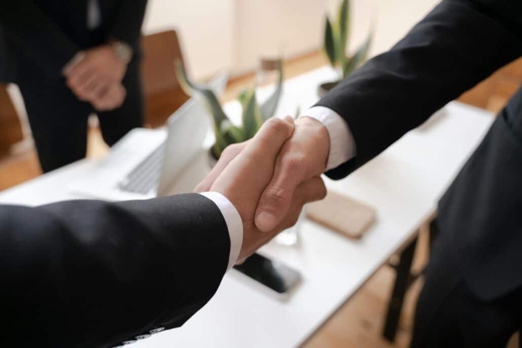 two people in suits shaking hands